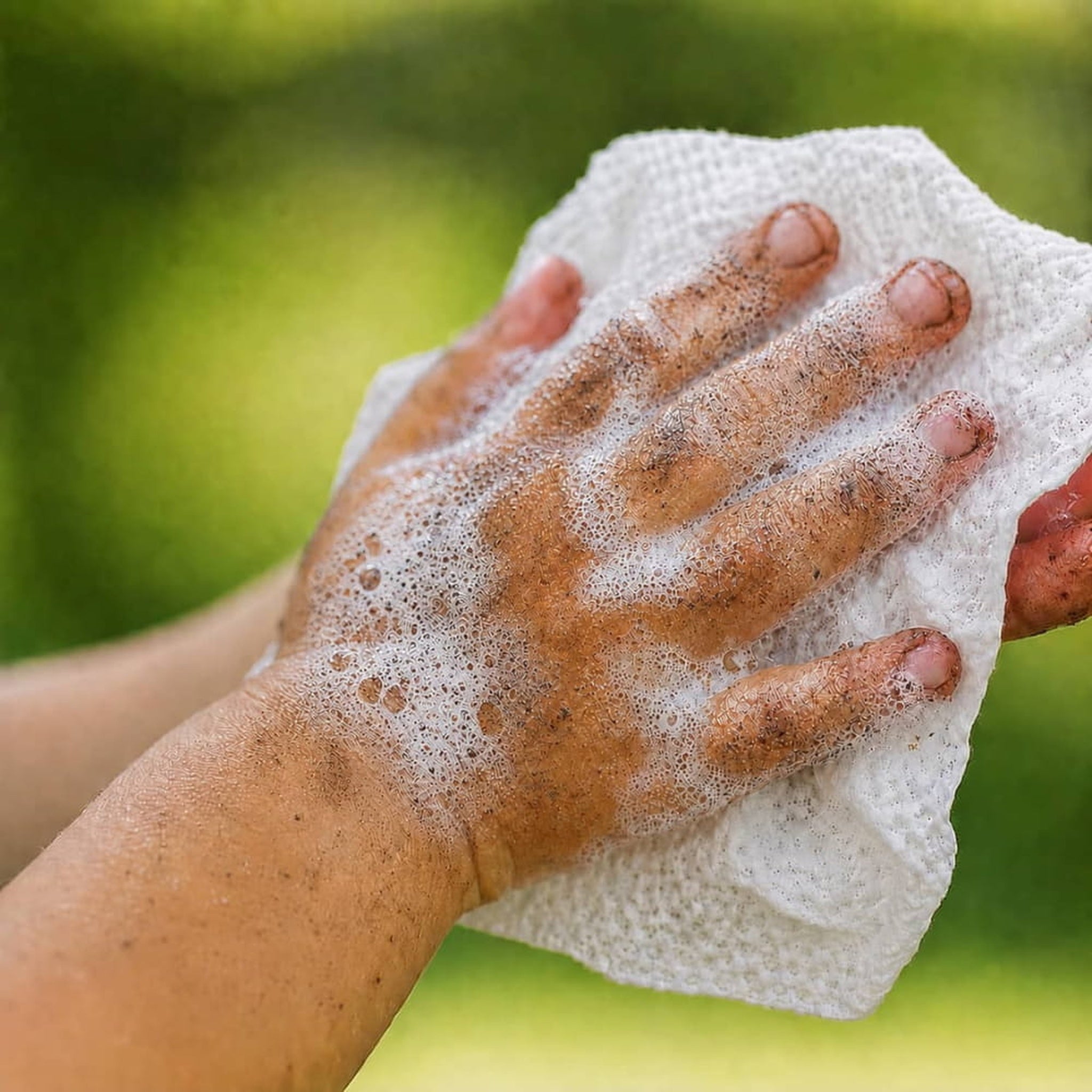 Step 1 close-up of a Bubbez plant-based WASH wipe in use on hands
