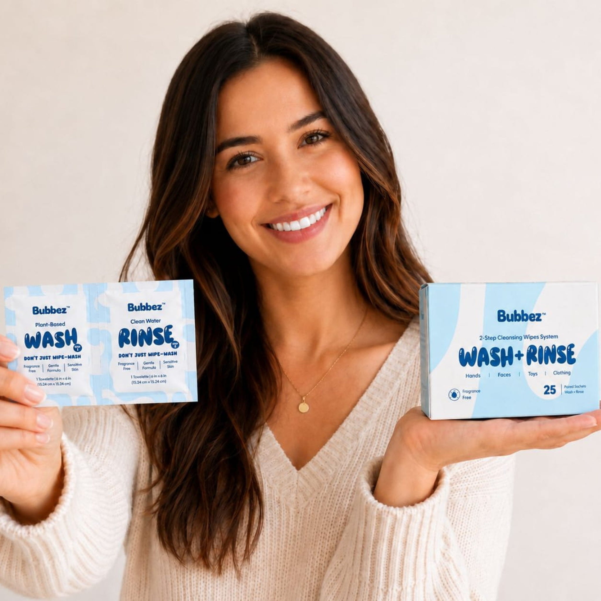 Woman displaying Bubbez box and twin sachet together, alternate crop