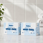 Two boxes of Bubbez Wash + Rinse wipes system on a bathroom counter.