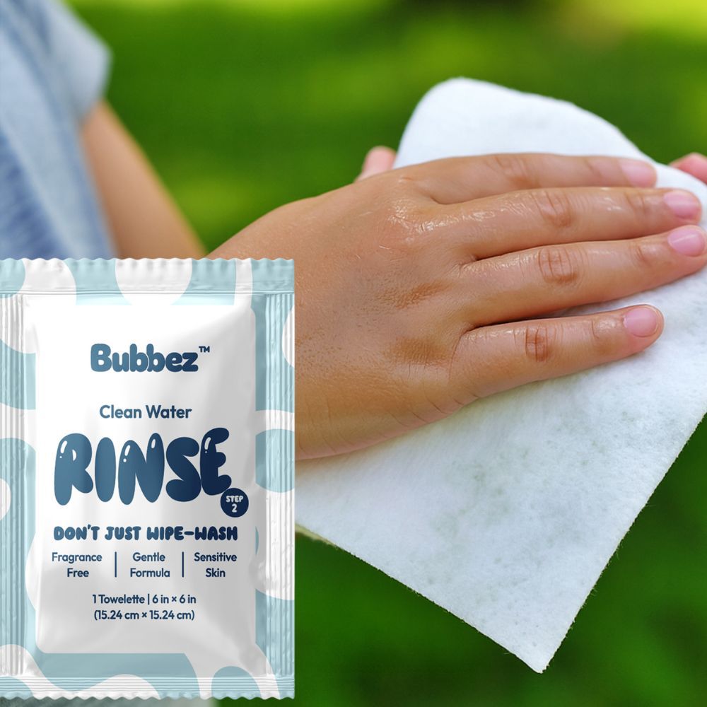 Bubbez Clean Water Rinse packet with a hand using a towel against a green background