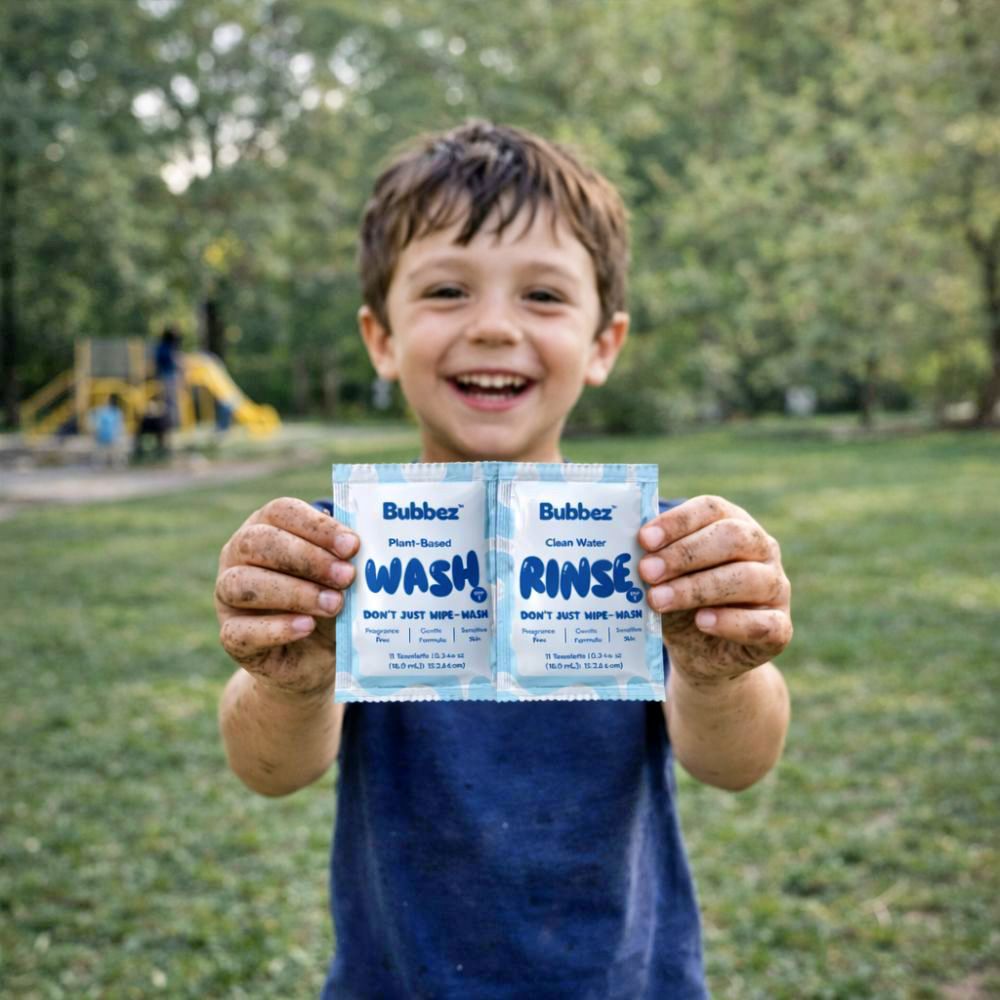 Child holding Bubbez wash and rinse packets in a park