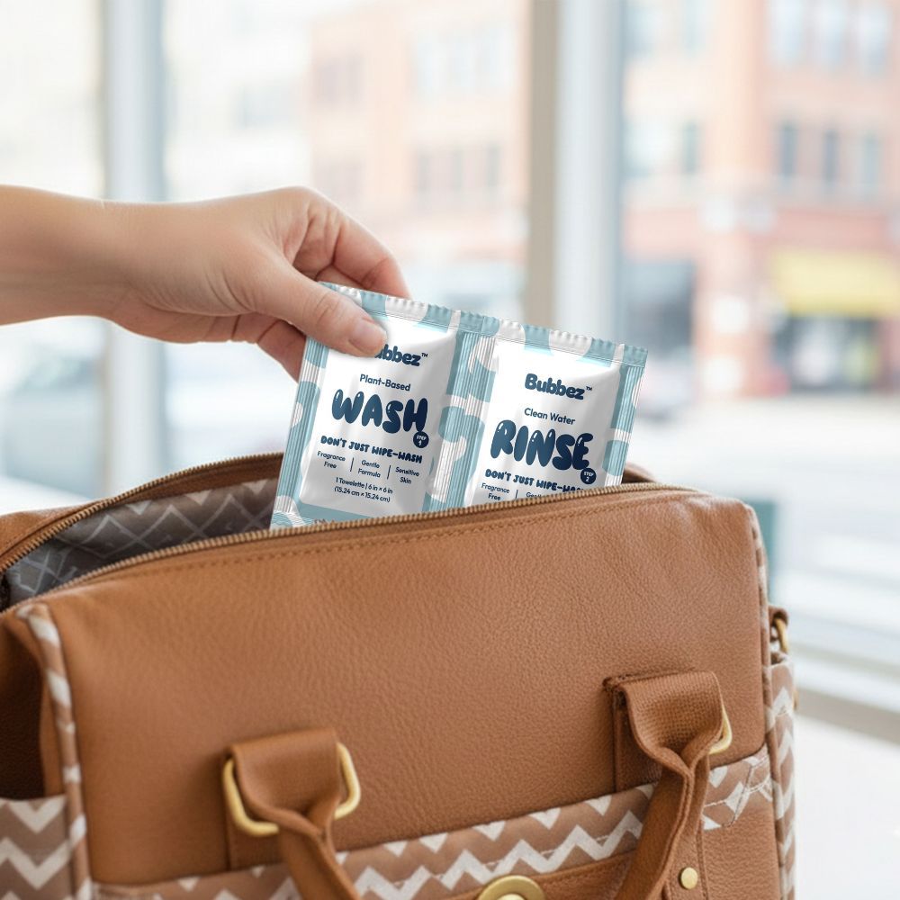 Person holding Bubbaz cleaning packets over a brown bag with a blurred background